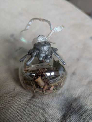 Glass orb filled with crystals and herbs