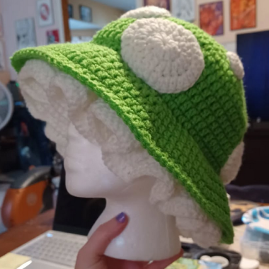A crocheted green mushroom shaped hat